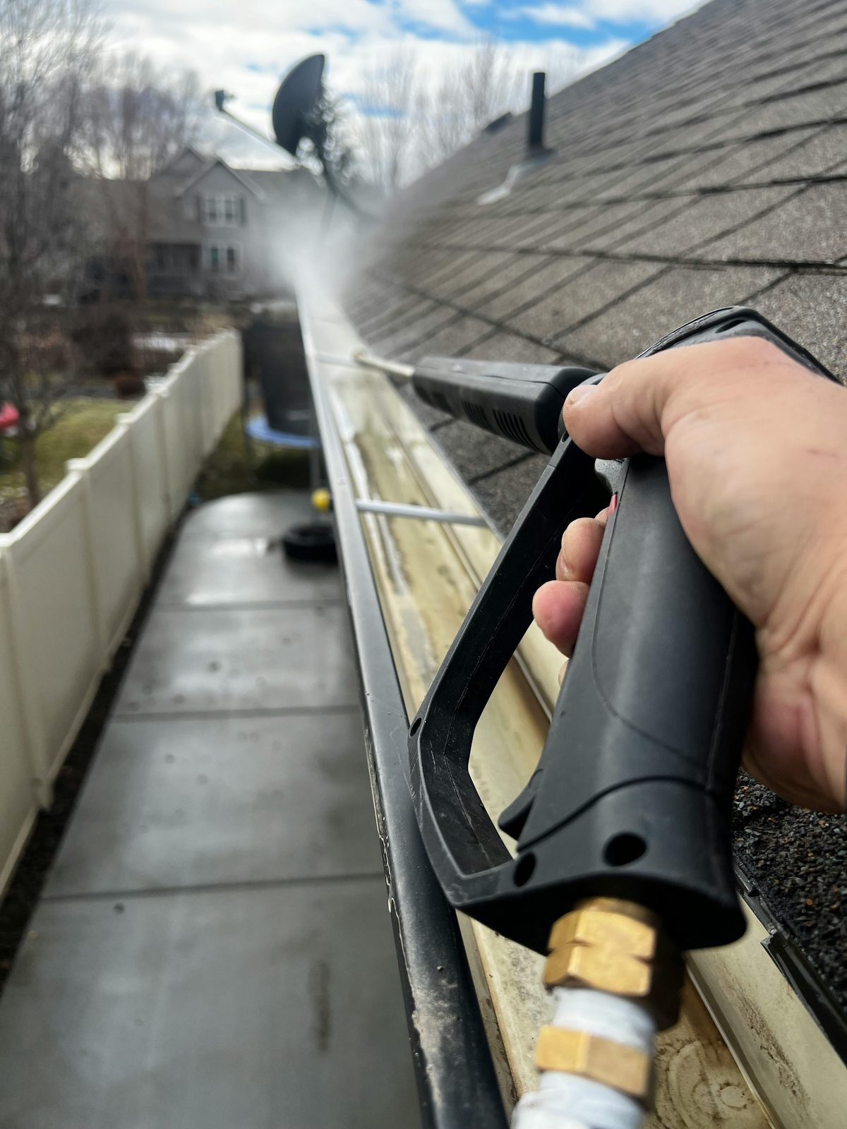 Close-up of gutter cleaning with high-pressure washer